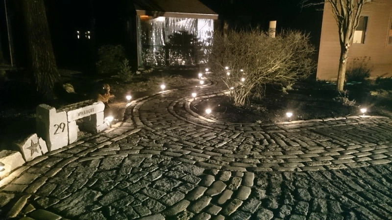 Cobblestone mosaic driveway at night in Little Sebago, Maine