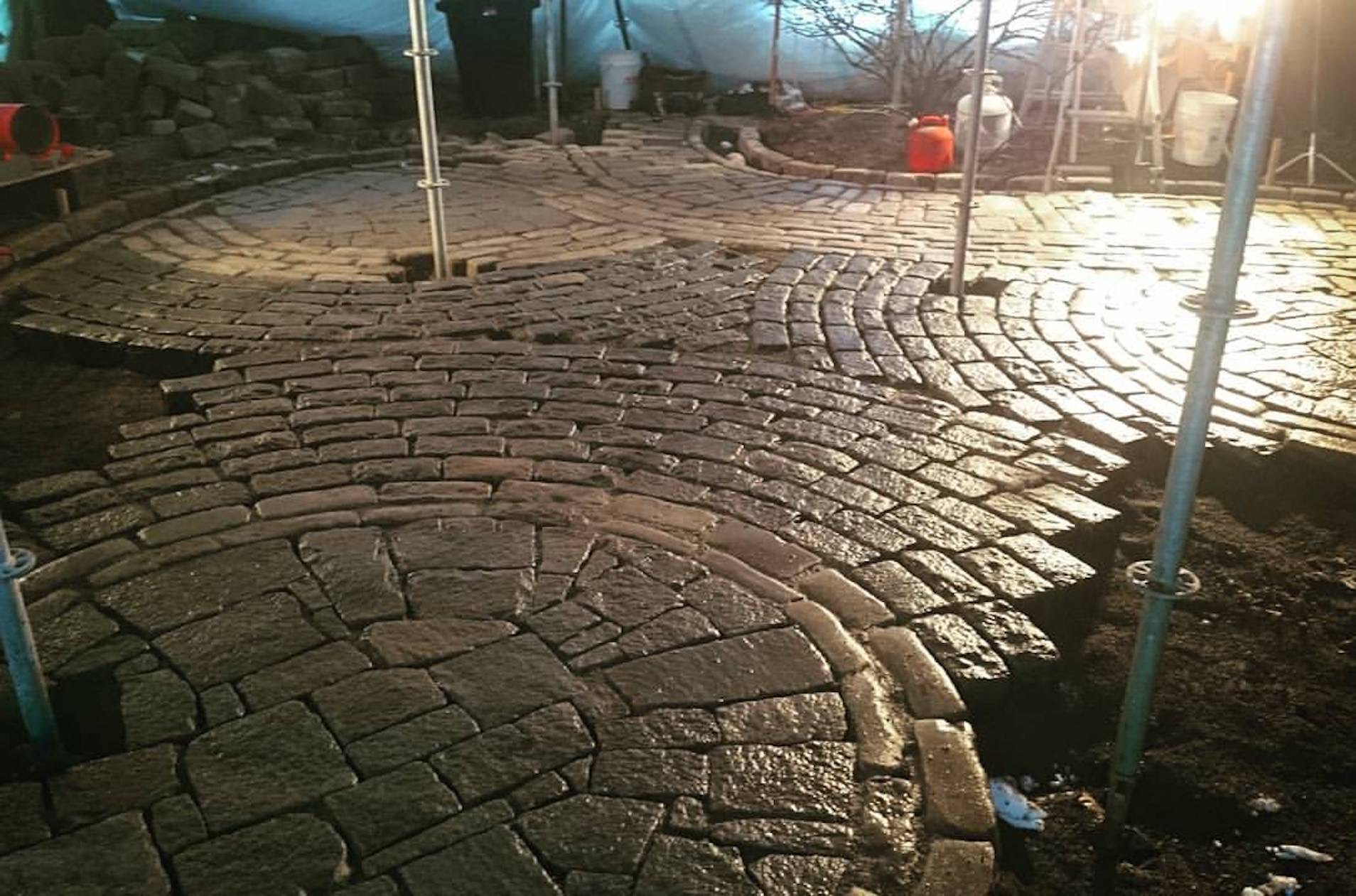 Tented installation of a cobblestone driveway