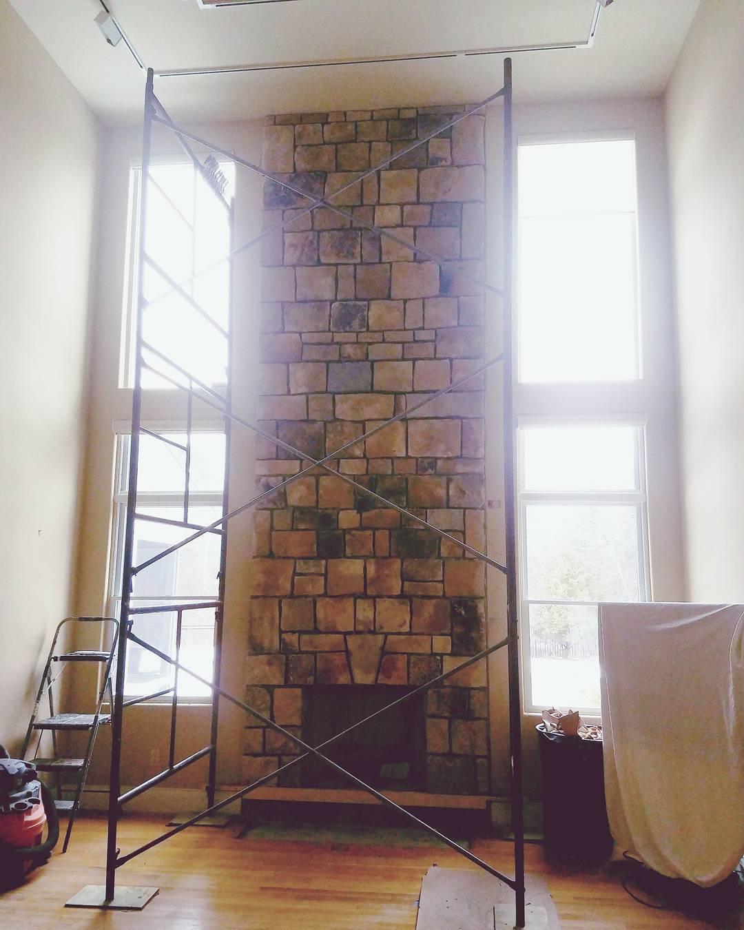 Too tall for the cameraman, this impressive fireplace surround is over 16 feet tall and made from South Bay Quartz thin-cut veneer stone. It makes a nice focal point in this great-room in Cumberland, Maine.