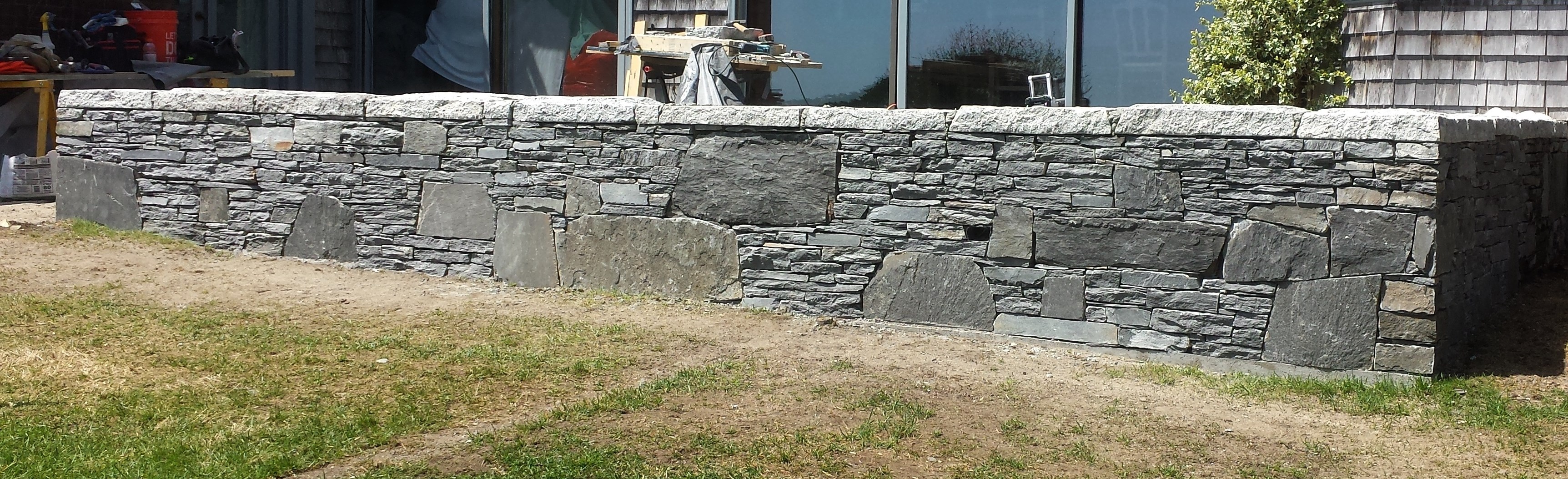 Once a crumbling mosaic wall, the stone was removed, hand-split onsite and reused in a stack wall. 